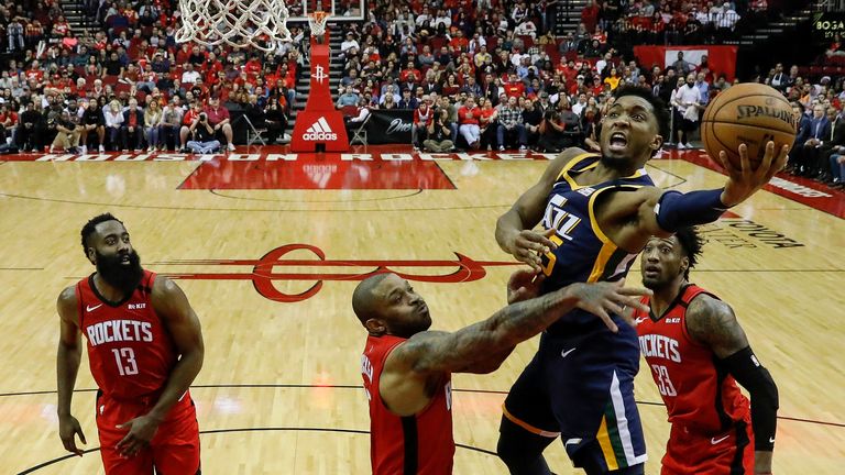 Donovan Mitchell of the Utah Jazz drives to the basket defended by P.J. Tucker of the Houston Rockets
