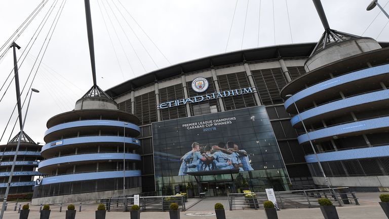 A new poster showing members of the Manchester City team celebrating has been placed at the entrance to the Etihad Stadium in Manchester, north west England to celebrate Manchester City winning the Premier League title on April 16, 2018. Pep Guardiola&#39;s side were crowned kings of English football yesterday as their arch rivals Manchester United slumped to a shock 1-0 defeat against struggling West Bromwich Albion