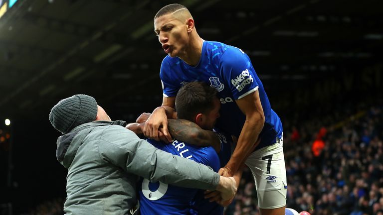 Theo Walcott is mobbed by Richarlison following his match-winning strike