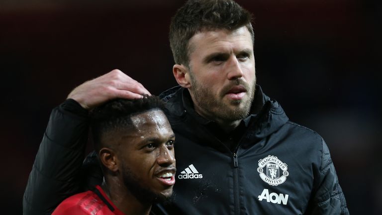 Manchester United midfielder Fred and assistant coach Michael Carrick
