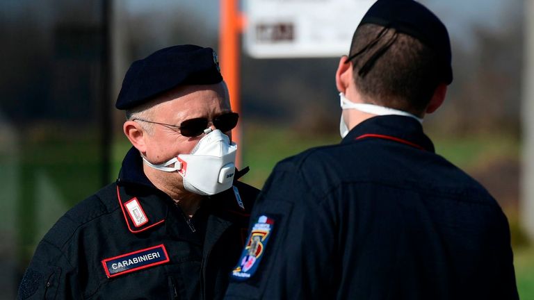 Police officers wear respiratory masks at a checkpoint amid the country's coronavirus outbreak