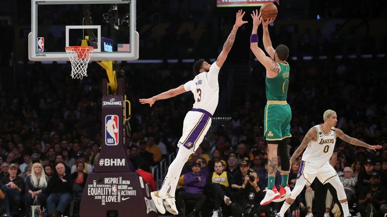 Jayson Tatum of the Boston Celtics shoots the ball against Anthony Davis of the Los Angeles Lakers