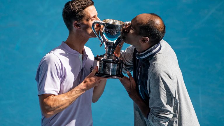 Joe Salisbury of Great Britain and Rajeev Ram of the United States celebrate with the trophy after winning the men's doubles final against Luke Saville and Max Purcell of Australia on day fourteen of the 2020 Australian Open at Melbourne Park on February 02, 2020 in Melbourne, Australia.        