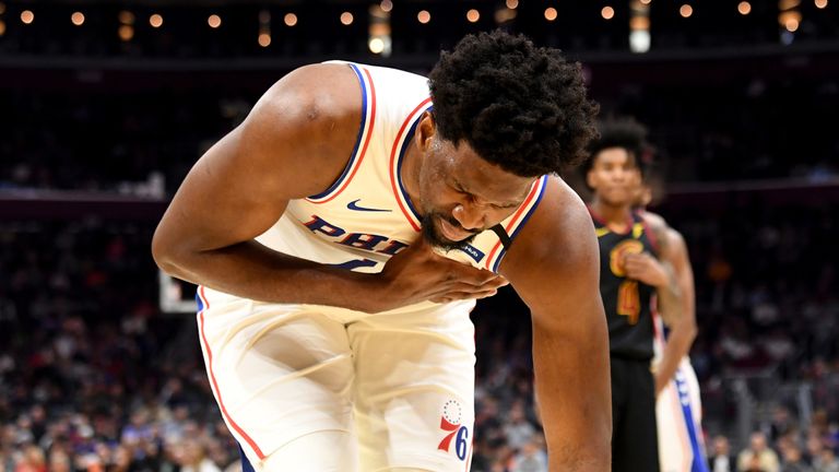 Joel Embiid reacts after suffering a shoulder injury in Philadelphia's loss in Cleveland