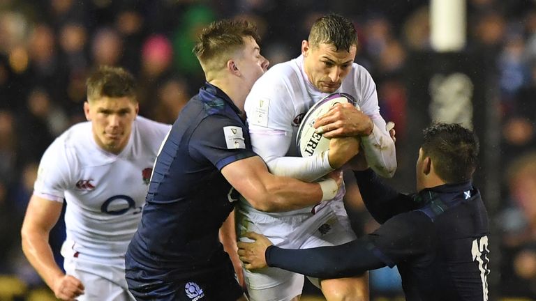 Jonny May is wrapped up by the Scotland defence