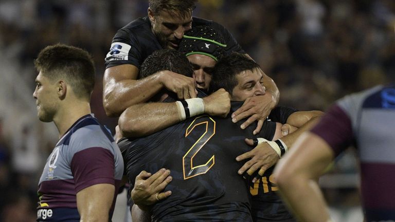 Julian Montoya celebrates with his Jaguares team-mates after scoring his third try