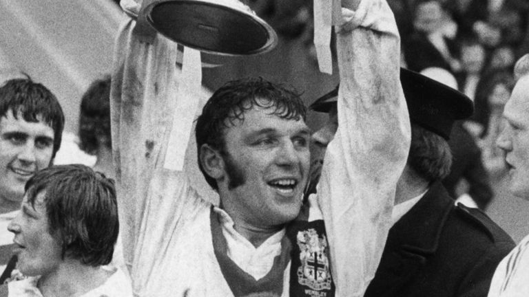 13th April 1972: Hot and sweaty, St Helens' captain Kelvin Coslett holds up the Rugby League cup after his team beat Leeds 16 - 13 at Wembley stadium in London. A trainer holds their teddy bear mascot. (Photo by Central Press/Getty Images)