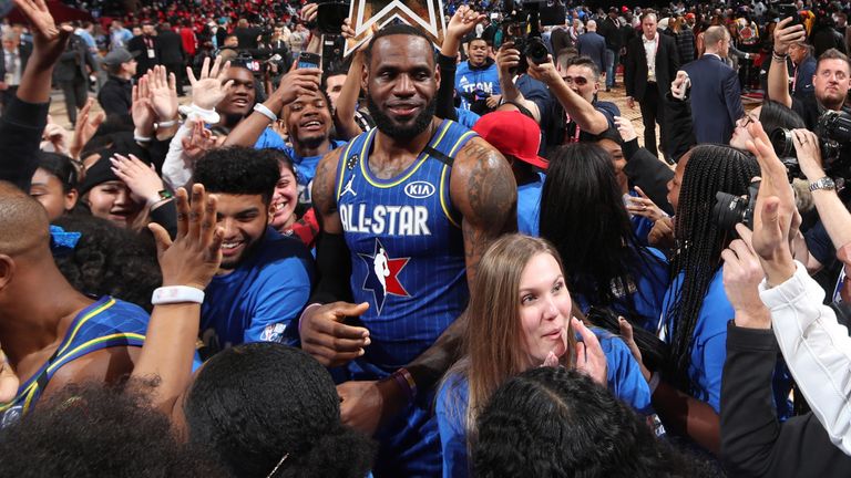 LeBron James celebrates with team-mates and Chicago schoolchildren at the end of the All-Star Game