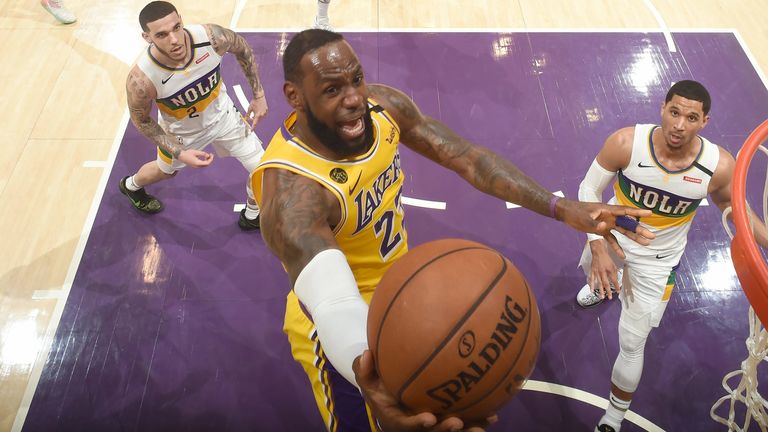 LeBron James scores at the rim during the Lakers' victory over the Pelicans