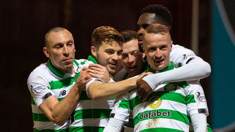 Leigh Griffiths celebrates with Celtic team-mates after scoring against Motherwell