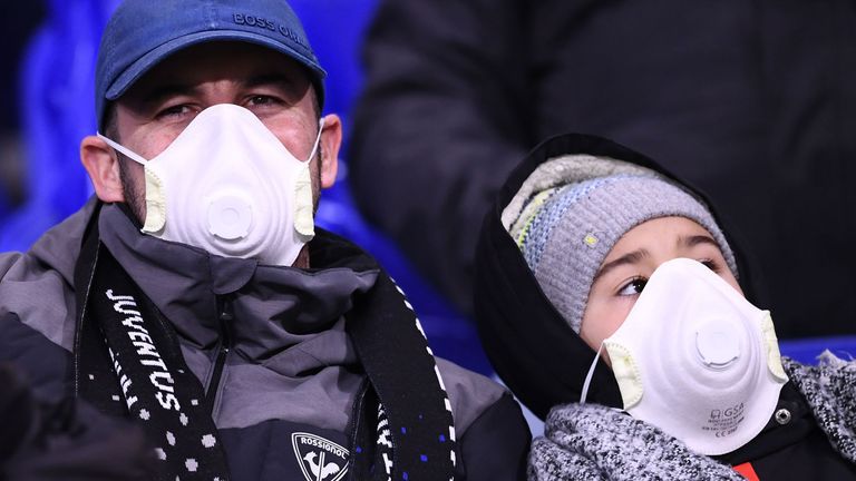 Juventus fans are pictured wearing protective masks during the UEFA Champions League, round of 16 first-leg match against Lyon