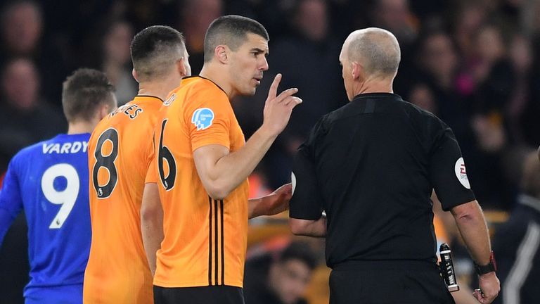 Conor Coady and Mike Dean talk at half-time after a Wolves goal was disallowed for offside via VAR