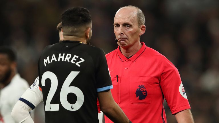 Referee Mike Dean speaks to Riyad Mahrez during Manchester City's game at Tottenham