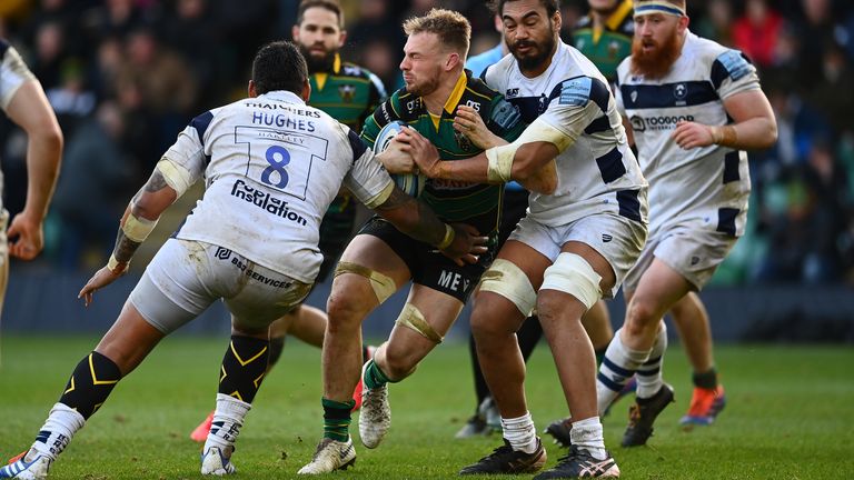 NORTHAMPTON, ENGLAND - FEBRUARY 16: Mitch Eadie of Northampton Saints is tackled by Nathan Hughes of Bristol Bears and Chris Vui of Bristol Bears during the Gallagher Premiership Rugby match between Northampton Saints and Bristol Bears at Franklin's Gardens on February 16, 2020 in Northampton, England. (Photo by Clive Mason/Getty Images)