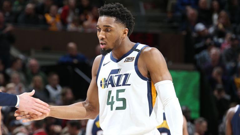 Donovan Mitchell of the Utah Jazz high-fives teammates against the Denver Nuggets