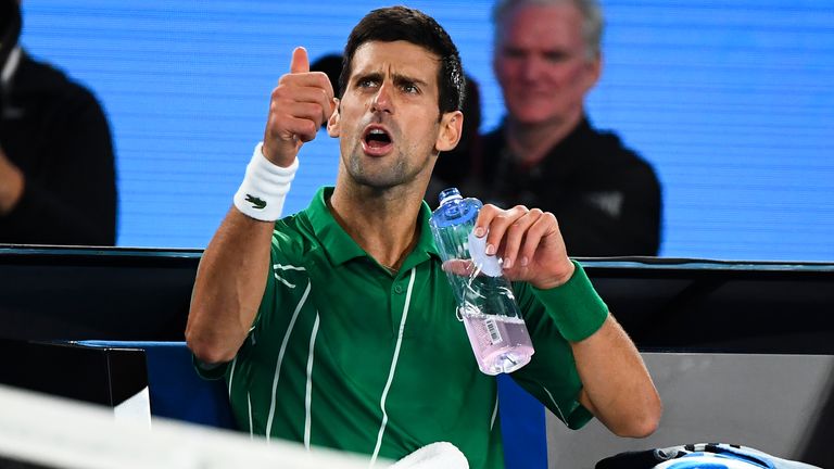 Serbia's Novak Djokovic reacts during a break in his men's singles final match against Austria's Dominic Thiem on day fourteen of the Australian Open tennis tournament in Melbourne on February 2, 2020