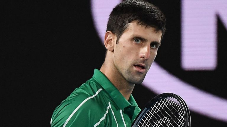 Serbia&#39;s Novak Djokovic reacts as he plays against Austria&#39;s Dominic Thiem during their men&#39;s singles final match on day fourteen of the Australian Open tennis tournament in Melbourne on February 2, 2020