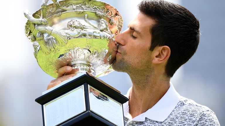 Novak Djokovic of Serbia poses during the 2020 Australian Open Men's Trophy Media Opportunity at Royal Botanic Gardens Victoria on February 03, 2020 in Melbourne, Australia