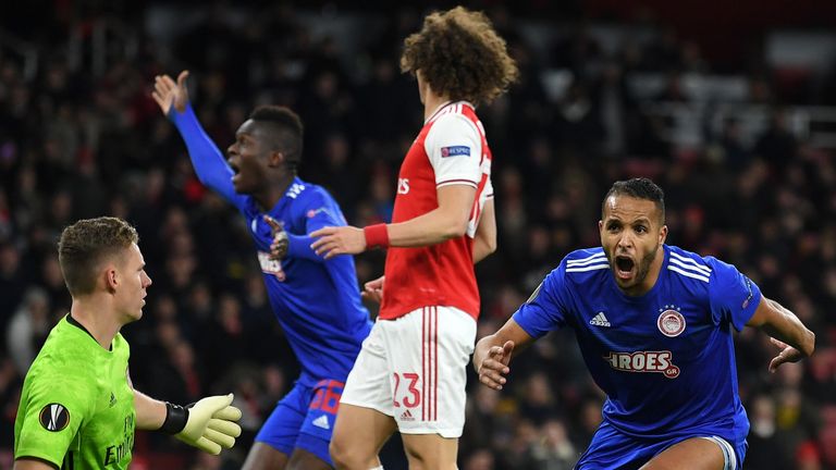 Youssef El Arabi of Olympiakos FC celebrates after scoring his team's second goal against Arsenal