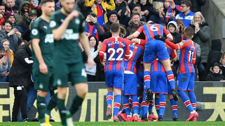 Patrick van Aanholt is mobbed by team-mates after opening the scoring against Newcastle