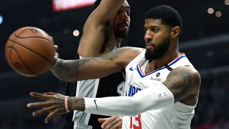 Paul George throws an airborne pass against the Spurs