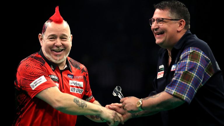 Peter Wright shakes hands with Gary Anderson before their match during day two of the Unibet Premier League at Motorpoint Arena on February 13, 2020 in Nottingham, England