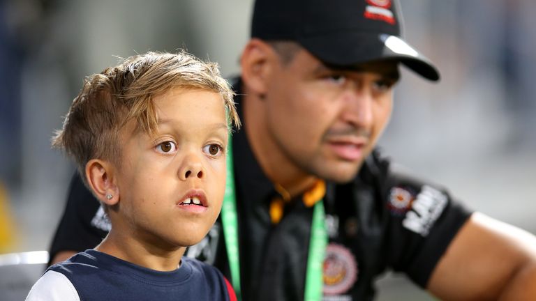 Quaden Bayles looks on from the sideline with Cody Walker of the Indigenous All-Stars