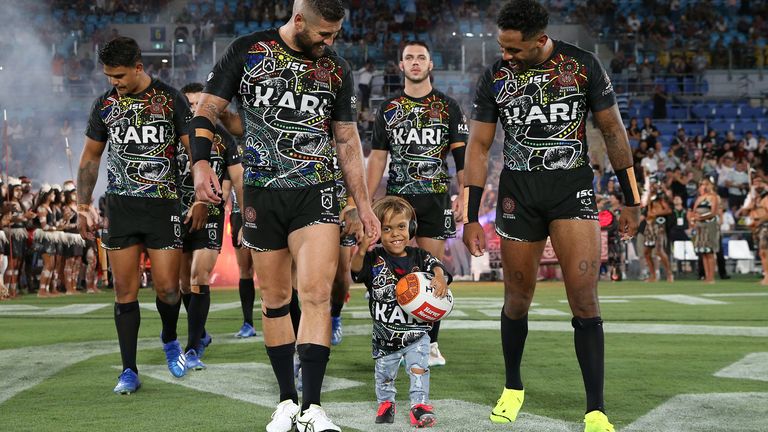 Quaden Bayles leads out the Indigenous All-Stars