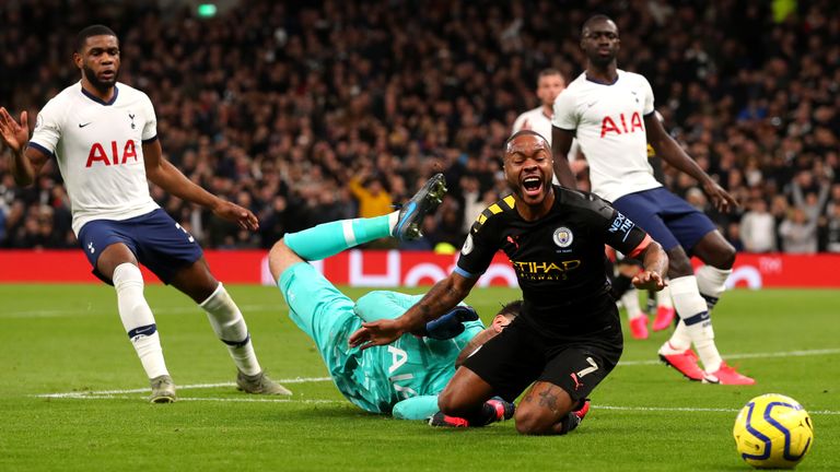 Hugo Lloris' challenges Raheem Sterling in the penalty area