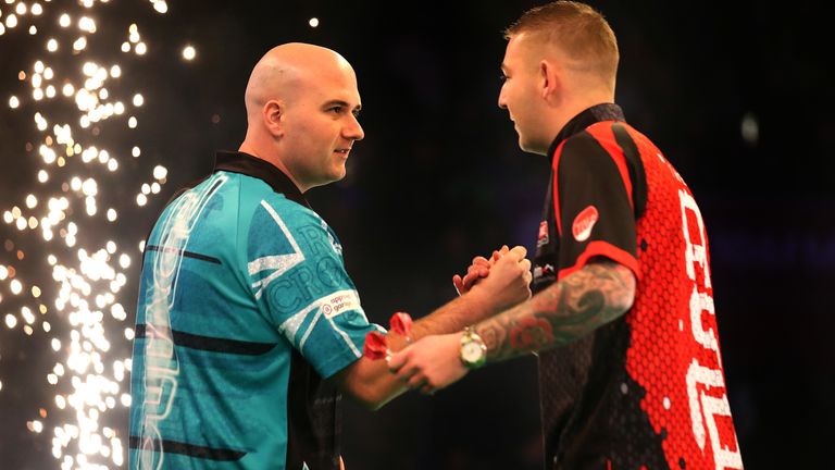 Rob Cross shakes hands with Nathan Aspinall ahead of their match during day two of the Unibet Premier League at Motorpoint Arena on February 13, 2020 in Nottingham, England
