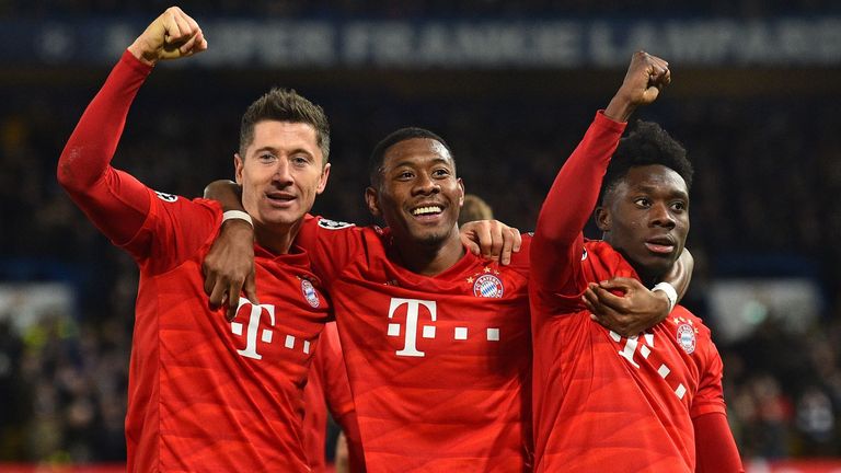 Robert Lewandowski (L) celebrates with David Alaba and Alphonso Davies after scoring against Chelsea