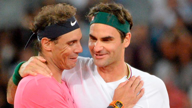 Switzerland's Roger Federer (R) hugs Spain's Rafael Nadal (L) during their tennis match at The Match in Africa at the Cape Town Stadium, in Cape Town on February 7, 2020. 