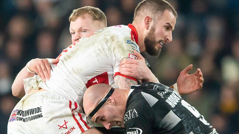 Hull KR tryscorer Ben Crooks is tackled by Hull FC duo Jordan Johnston and Danny Houghton