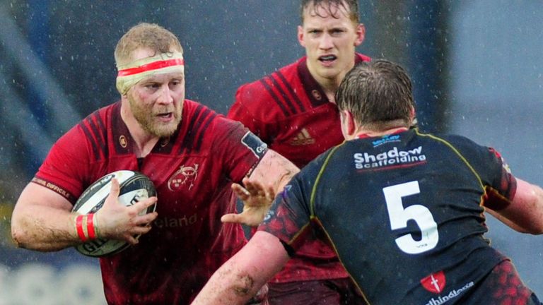 Jeremy Loughman (L) of Munster in action against the Dragons