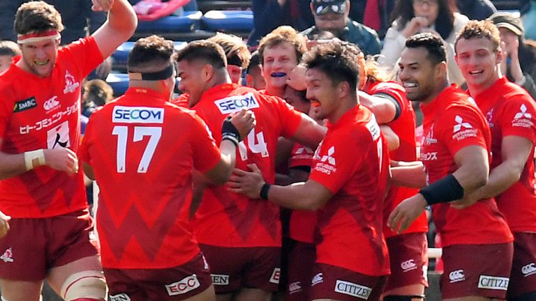 Sunwolves celebrate a try against the Rebels