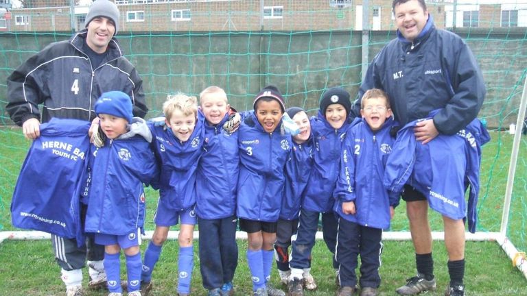 Sam McCallum (C) pictured with team-mates and coaches at Herne Bay Youth FC