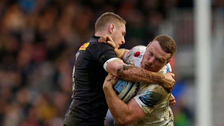 Sam Simmonds of Exeter Chiefs is tackled by Tom Penny of Harlequin