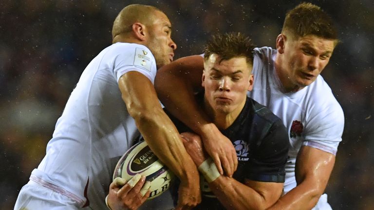 Huw Jones is stopped by Owen Farrell and Jonathan Joseph