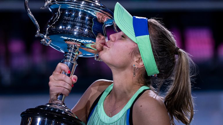 Sofia Kenin of the United States celebrates with the trophy after winning the women's singles final match against Garbine Muguruza of Spain on day thirteen of the 2020 Australian Open at Melbourne Park on February 01, 2020 in Melbourne, Australia