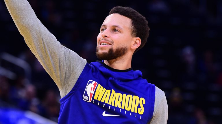 Stephen Curry shoots during warm-ups at a Warriors game