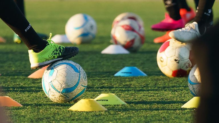 Stock image of young girls playing football