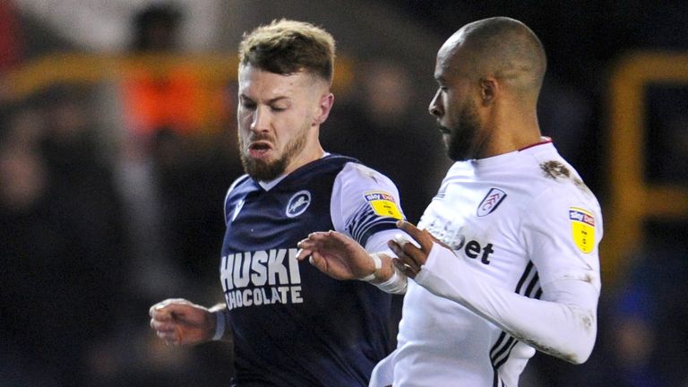 Tom Bradshaw of Millwall is challenged by Denis Odoi of Fulham 