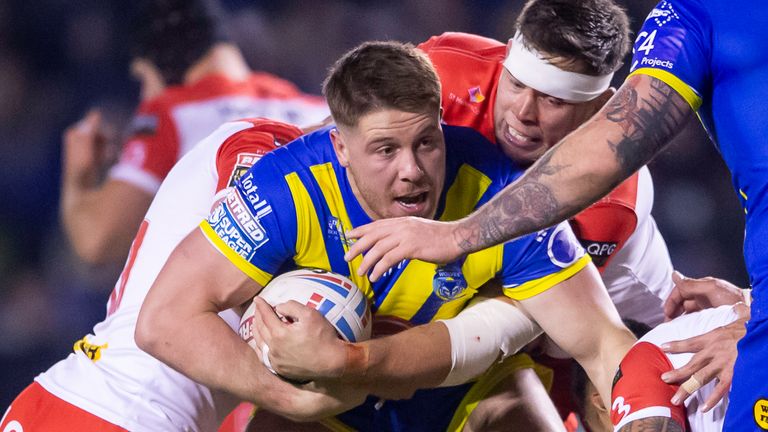 Warrington's Tom Lineham is tackled by St Helens's Louis McCarthy-Scarsbrook.