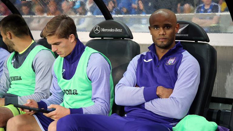 Kompany takes his seat in the dug-out during an Anderlecht game this term
