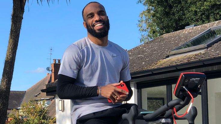 Alexandre Lacazette works out on an exercise bike