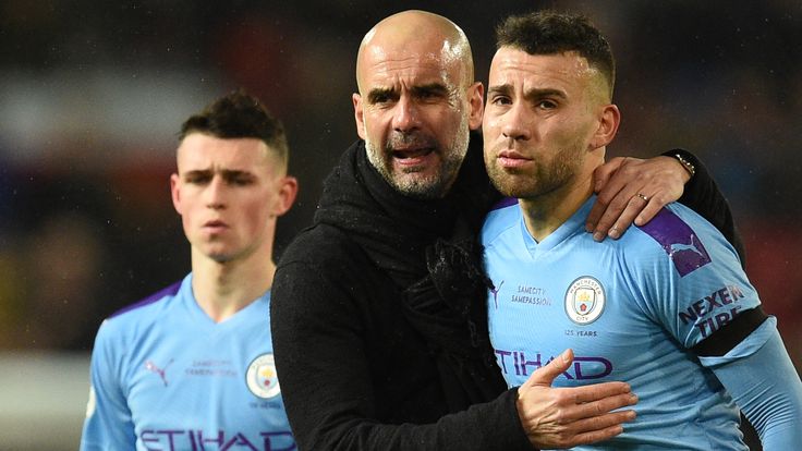 Pep Guardiola and Nicolas Otamendi after Manchester City's defeat at Manchester United