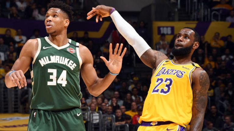  LeBron James of the Los Angeles Lakers holds the follow through while Giannis Antetokounmpo of the Milwaukee Bucks plays defense