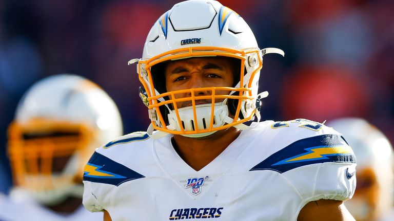 Running back Austin Ekeler #30 of the Los Angeles Chargers leads his team onto the field before a game against the Denver Broncos at Empower Field at Mile High on December 1, 2019 in Denver, Colorado.