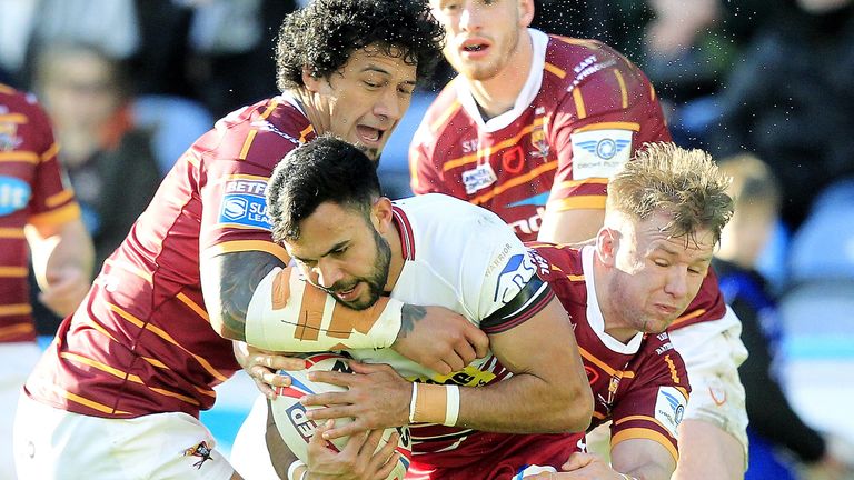 James Gavet and Aaron Murphy tackle Wigan's Bevan French