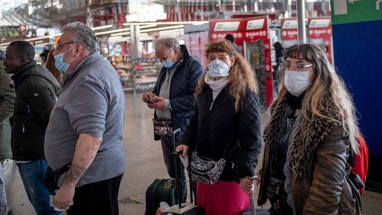 People wear face masks wait at the Termini Central Station during the Coronavirus emergency, on March 9, 2020 in Rome, Italy. Italian Prime Minister Giuseppe Conte announced the closure of the Italian region of Lombardy in an attempt to stop the ongoing coronavirus epidemic in the Italian country